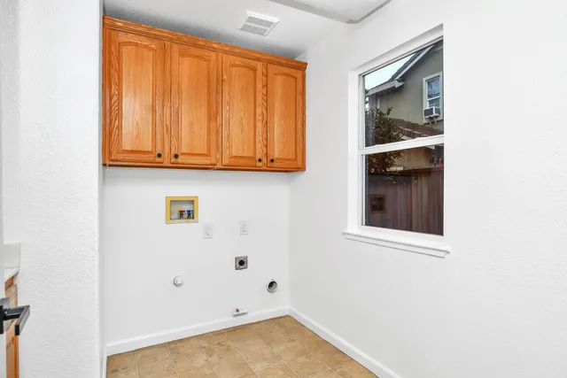 a view of an empty room with wooden floor and closet