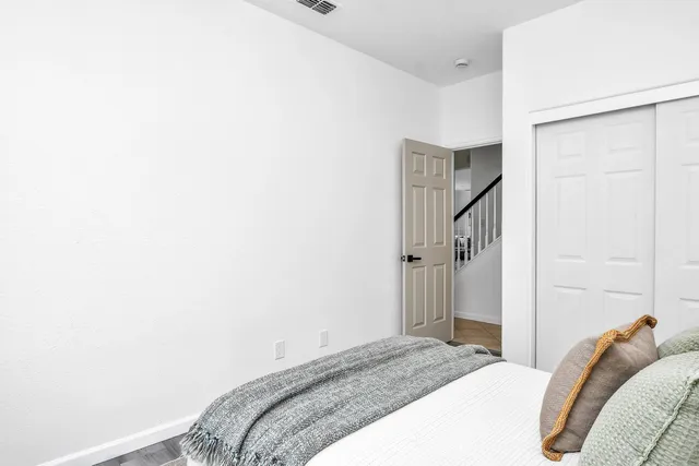 a bedroom with a bed and a wall painting