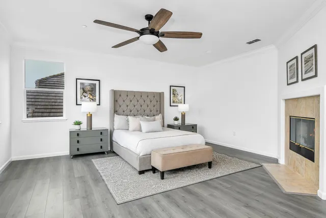 a bedroom with a large bed and a chandelier