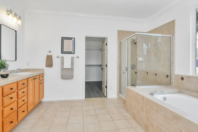 a bathroom with a tub sink and mirror