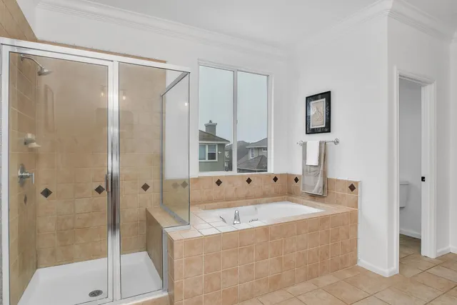 a bathroom with a tub a sink and a mirror