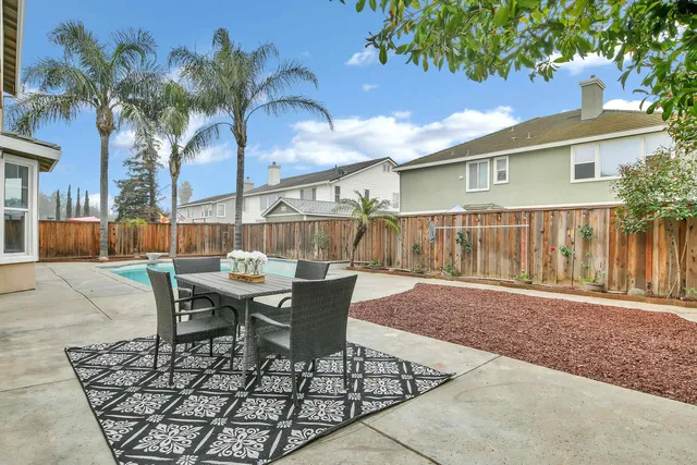 a view of a house with backyard and sitting area