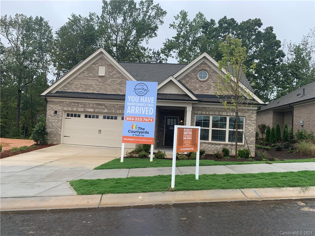 2064 New Style Way, Unit 40 Tega Cay, SC 29708 - Photo 1 of 16 a front view of a house with a yard and garage