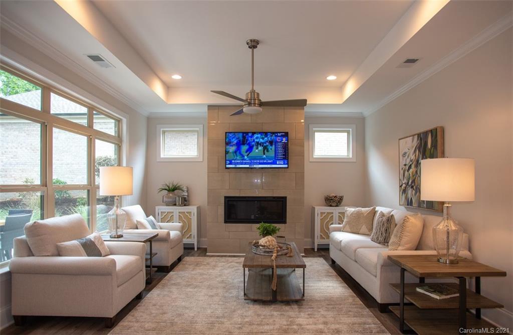 2064 New Style Way, Unit 40 Tega Cay, SC 29708 - Photo 11 of 16 a living room with furniture a flat screen tv and a large window