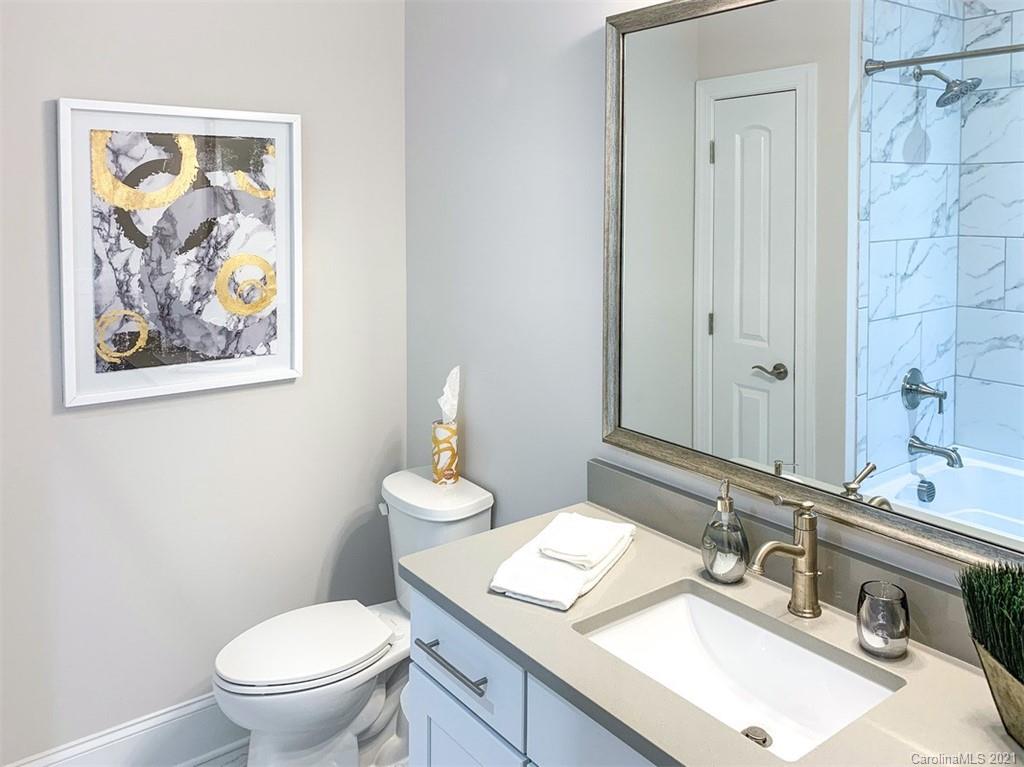 2064 New Style Way, Unit 40 Tega Cay, SC 29708 - Photo 14 of 16 a bathroom with a toilet a sink and mirror
