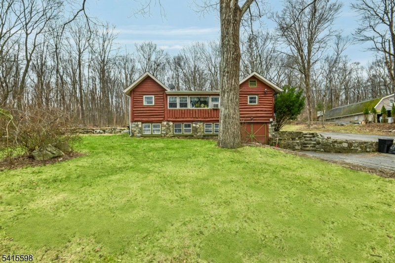 21 Grandview Avenue Oak Ridge, NJ 07438 - Photo 1 of 7 a view of a backyard with wooden fence and a bench