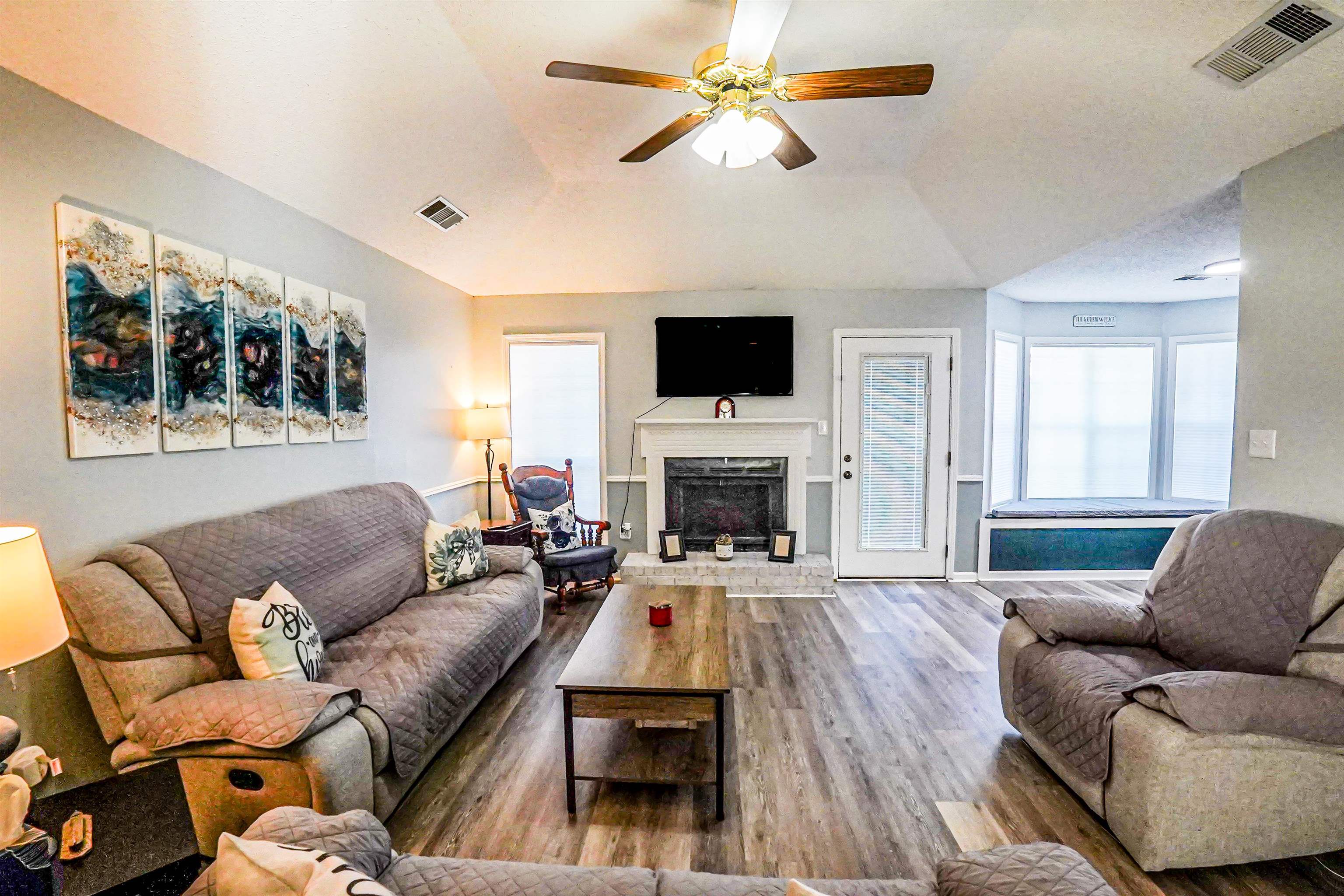 1336 Mathis Road Drummonds, TN 38023 - Photo 3 of 21 Living room with wood finished floors, a fireplace with raised hearth, a ceiling fan, and lofted ceiling
