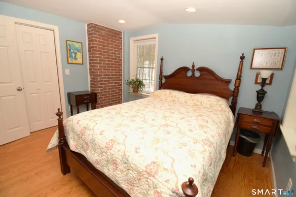 a bedroom with a bed and a dresser in it
