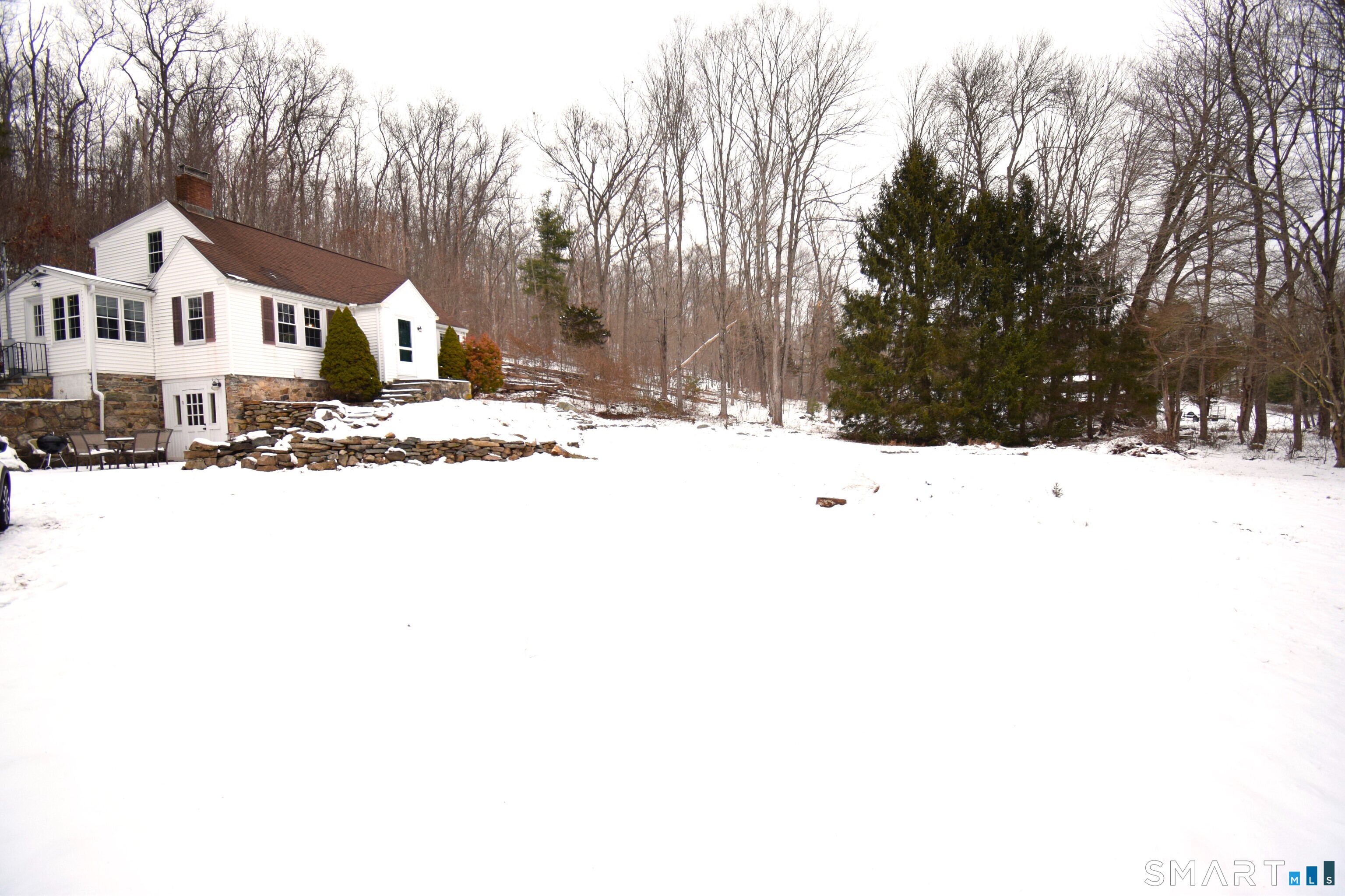2203 Durham Road Madison, CT 06443 - Photo 17 of 17 a front view of a house with a yard covered in snow