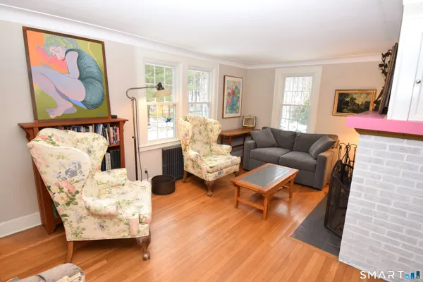 a living room with furniture and wooden floor
