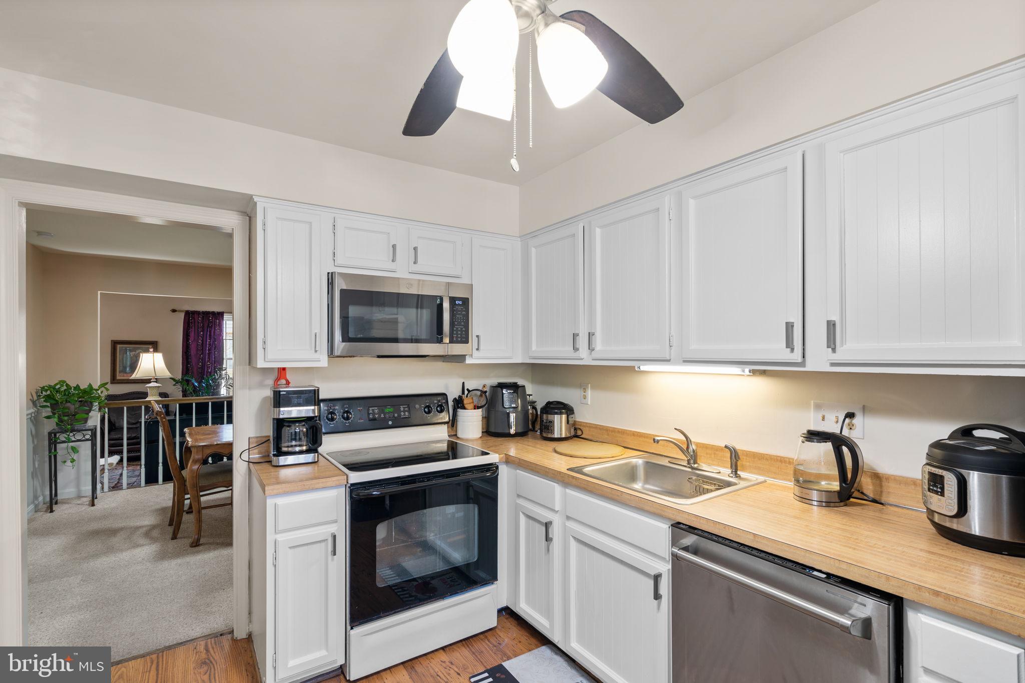 1043 Windrush Lane, Unit 5 Sandy Spring, MD 20860 - Photo 11 of 28 a kitchen with stainless steel appliances granite countertop a sink stove and cabinets