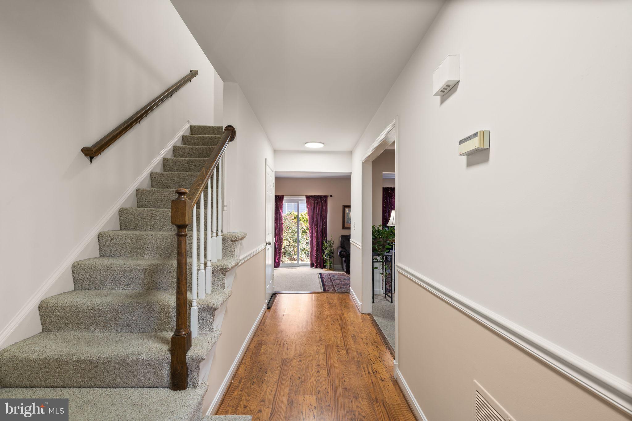 1043 Windrush Lane, Unit 5 Sandy Spring, MD 20860 - Photo 2 of 28 a view of a hallway with wooden floor and staircase