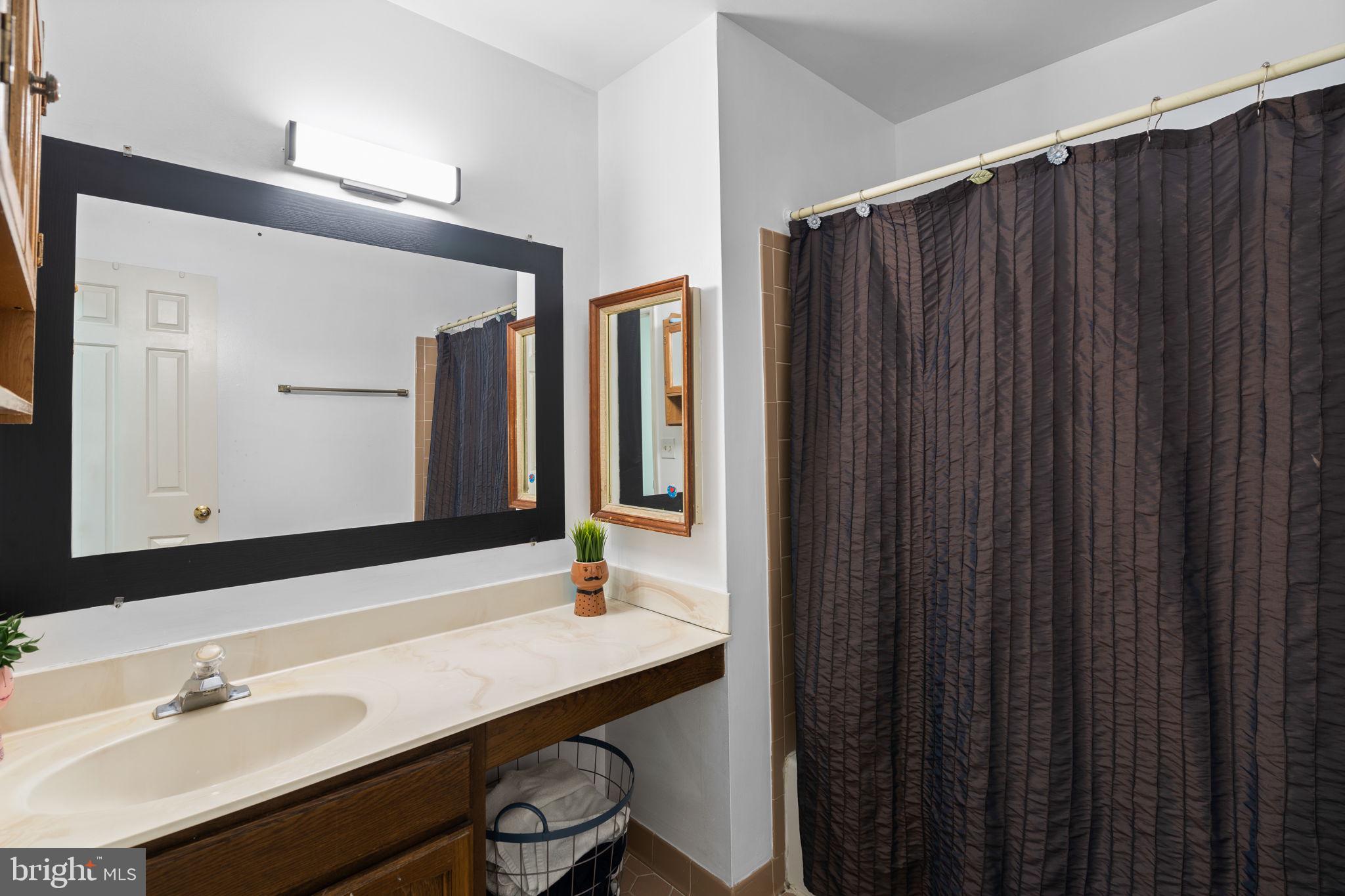 1043 Windrush Lane, Unit 5 Sandy Spring, MD 20860 - Photo 21 of 28 a bathroom with a sink and a mirror