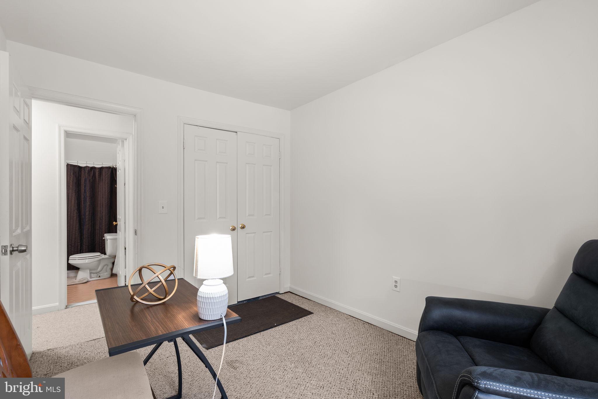 1043 Windrush Lane, Unit 5 Sandy Spring, MD 20860 - Photo 23 of 28 a living room with furniture and a flat screen tv