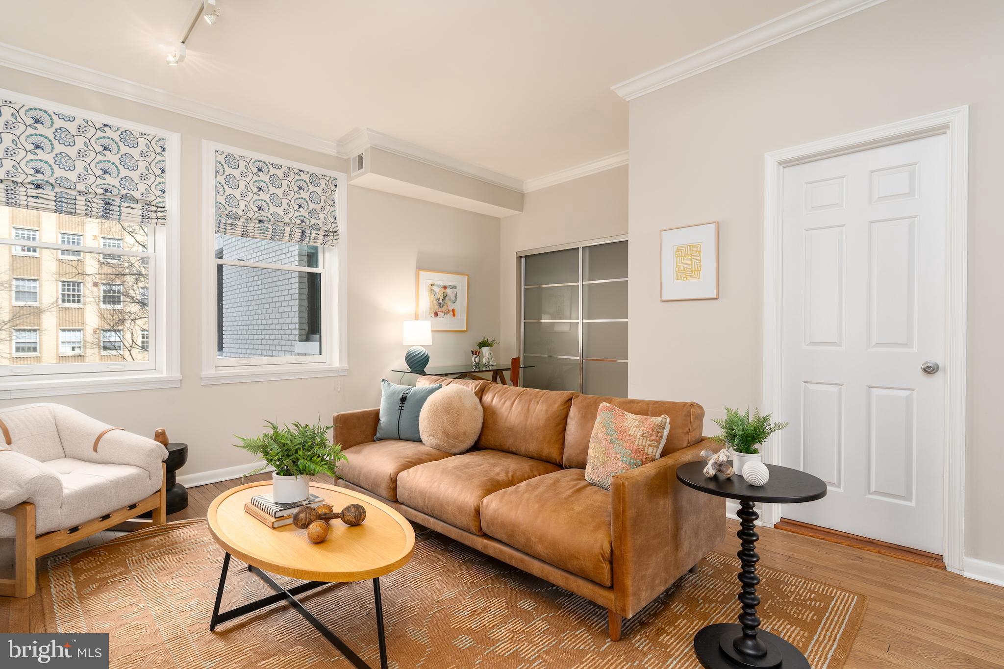2230 California Street Northwest, Unit 3BE Washington, DC 20008 - Photo 14 of 49 a living room with furniture a table and a window