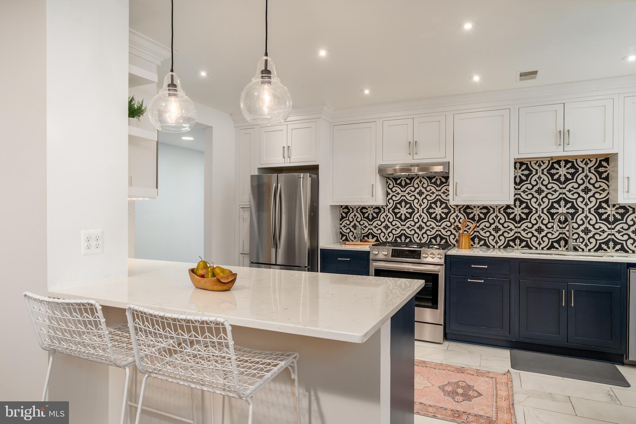 2230 California Street Northwest, Unit 3BE Washington, DC 20008 - Photo 23 of 49 a kitchen with stainless steel appliances granite countertop a sink and a refrigerator