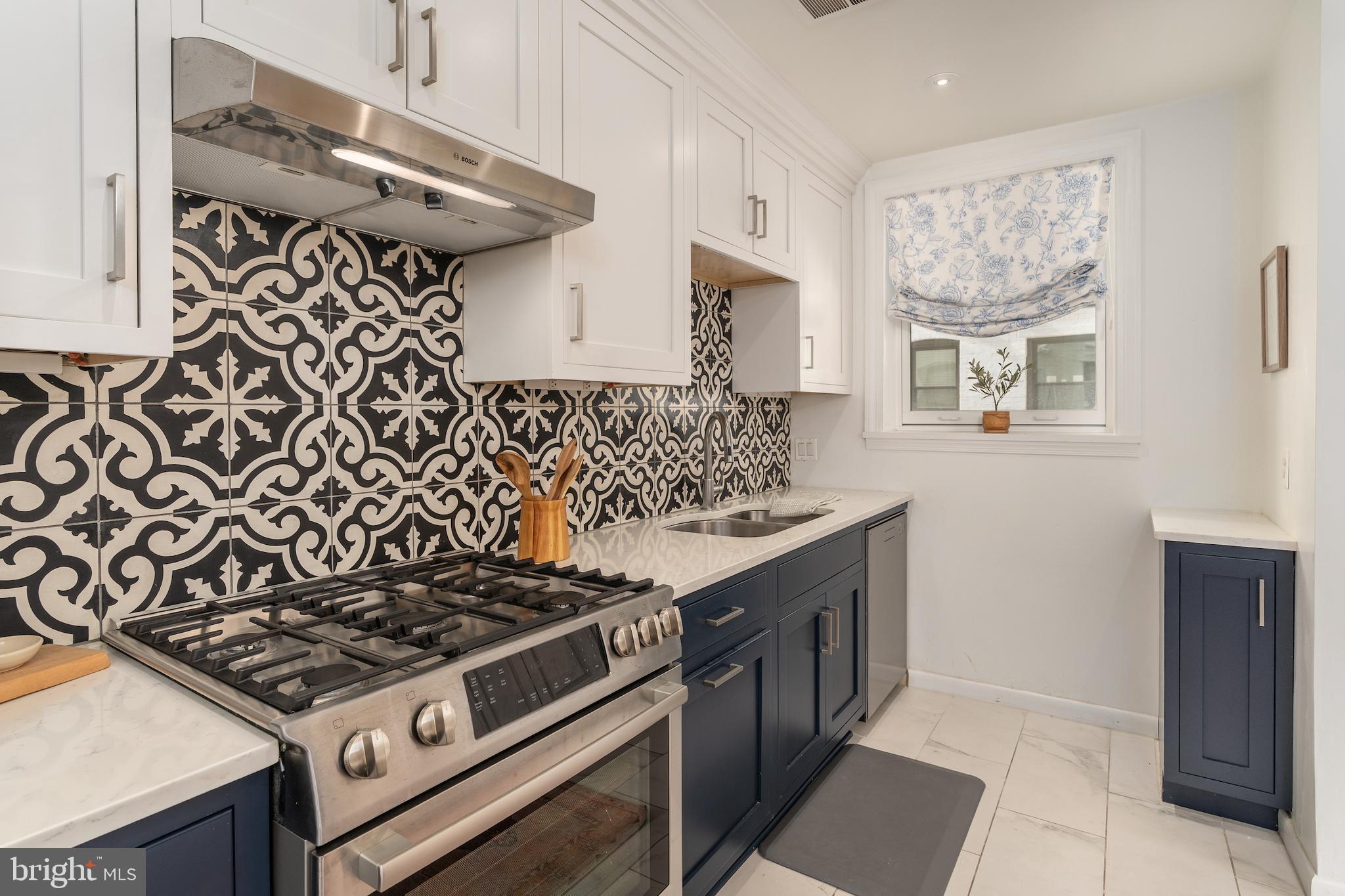 2230 California Street Northwest, Unit 3BE Washington, DC 20008 - Photo 25 of 49 a kitchen with a stove and a wooden cabinets