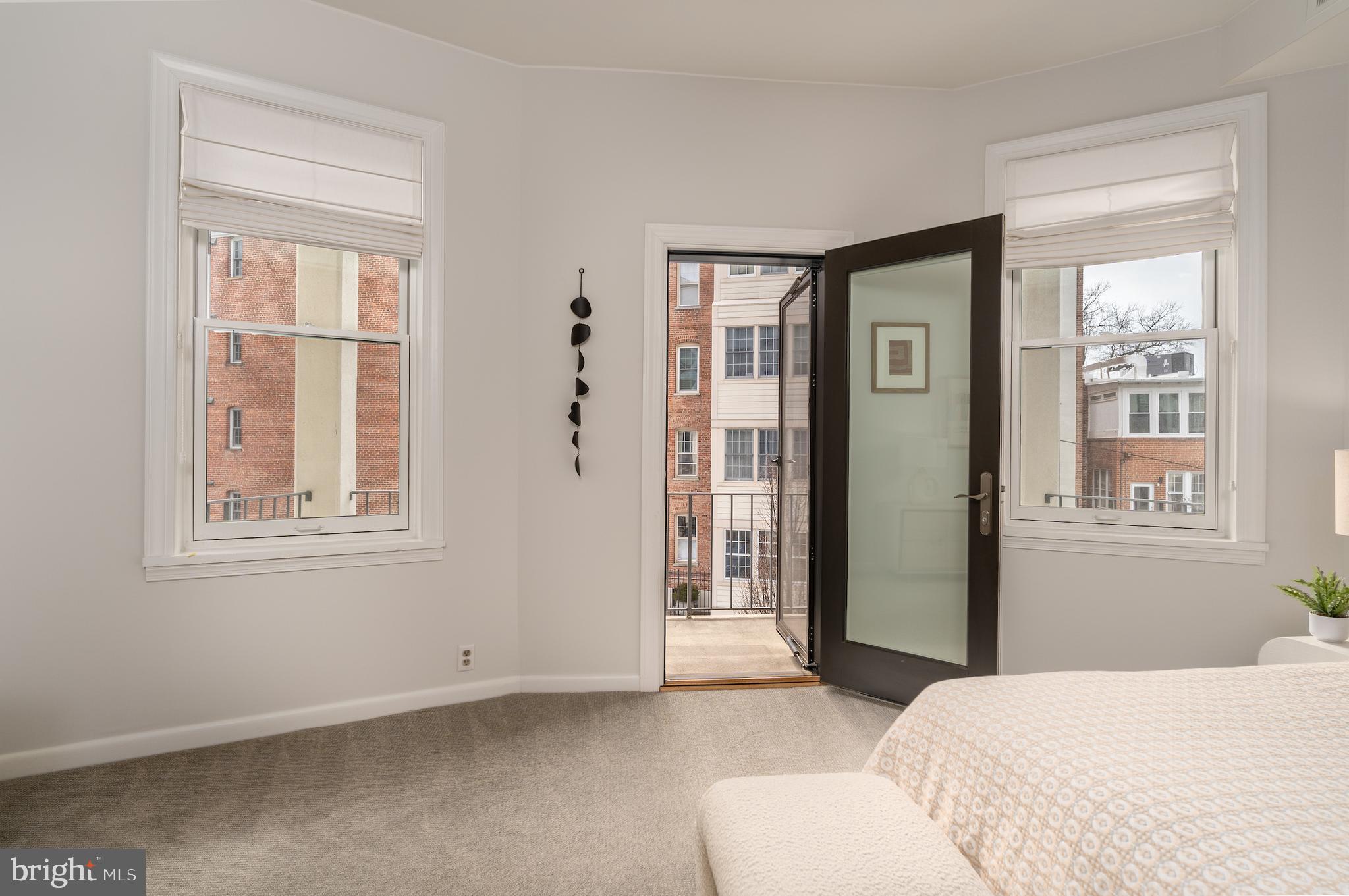 2230 California Street Northwest, Unit 3BE Washington, DC 20008 - Photo 31 of 49 a bedroom with a bed and a window
