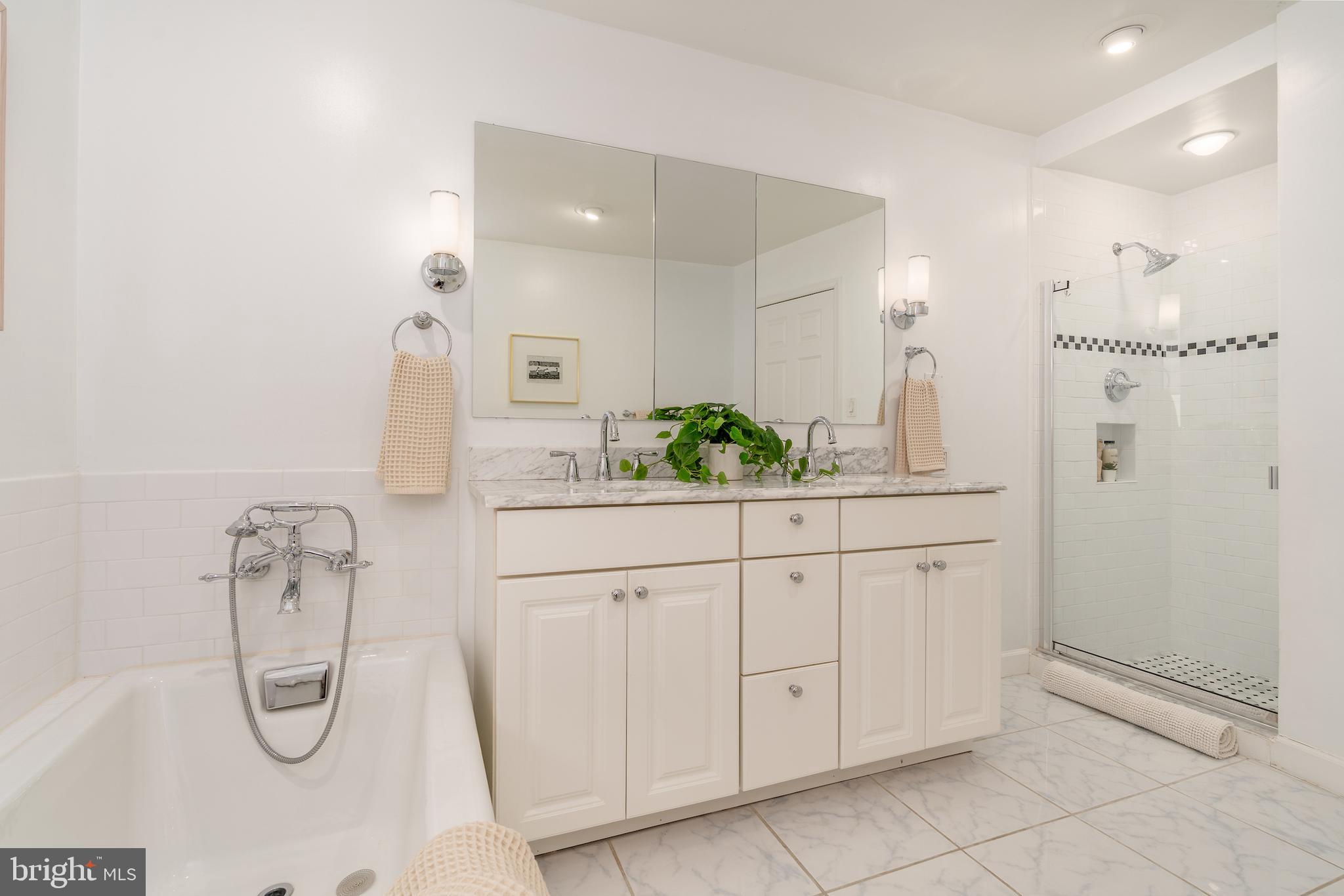 2230 California Street Northwest, Unit 3BE Washington, DC 20008 - Photo 35 of 49 a bathroom with a granite countertop sink a shower and a mirror