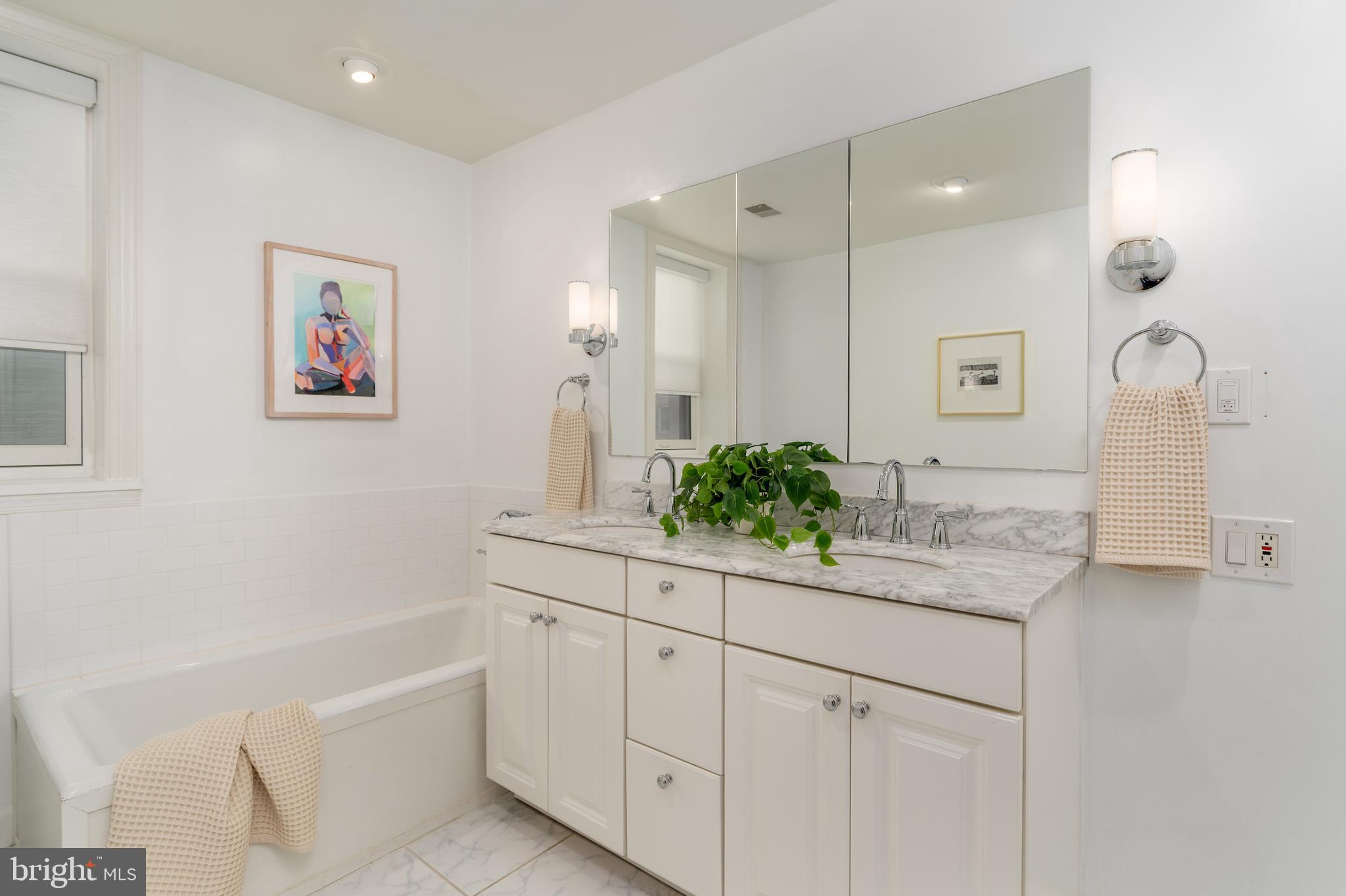 2230 California Street Northwest, Unit 3BE Washington, DC 20008 - Photo 36 of 49 a bathroom with a granite countertop sink a toilet a large mirror
