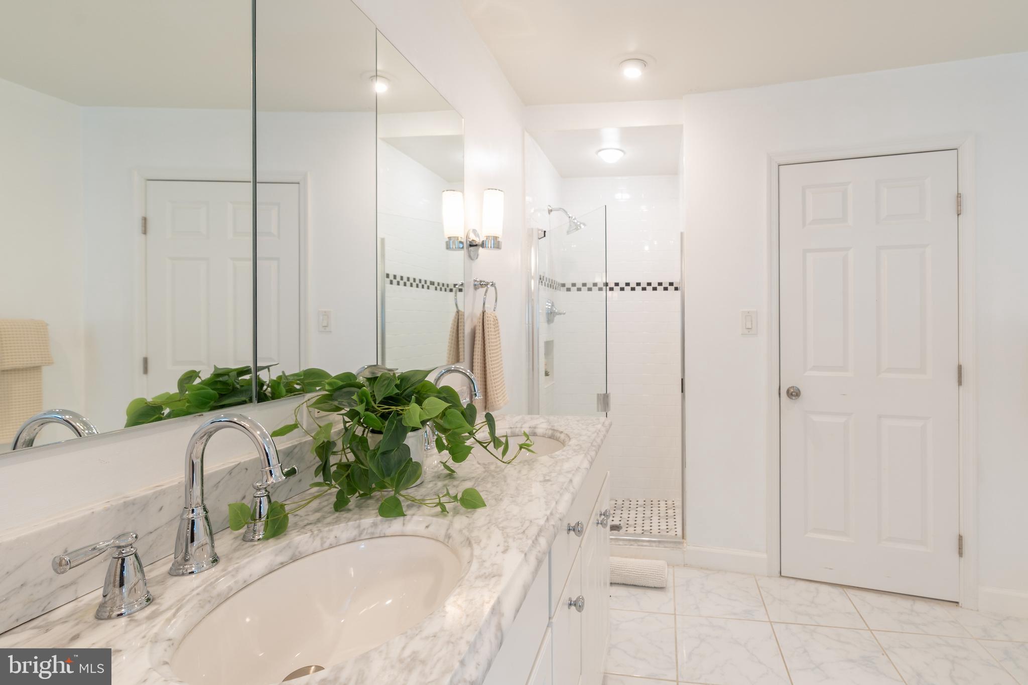 2230 California Street Northwest, Unit 3BE Washington, DC 20008 - Photo 37 of 49 a bathroom with a granite countertop sink a mirror and a bathtub