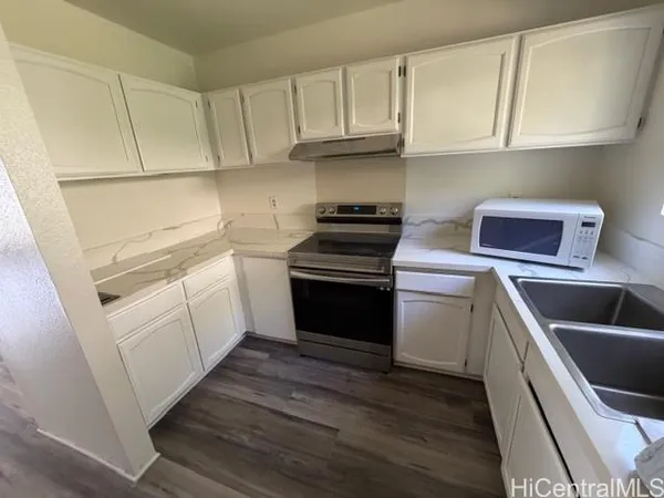 a kitchen with a sink stove and cabinets