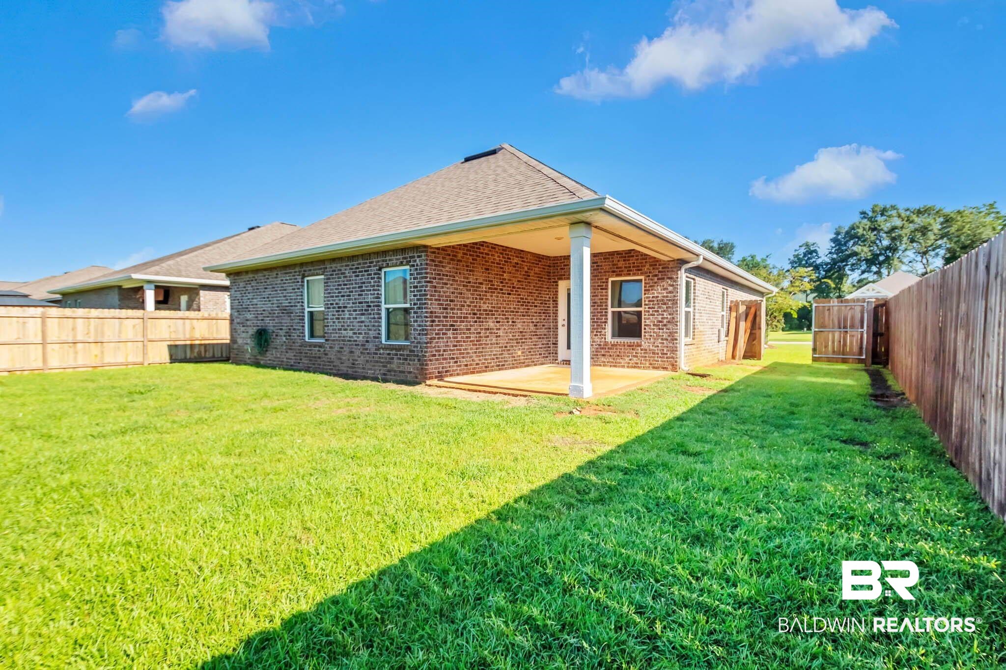 16461 Prado Loop Loxley, AL 36551 - Photo 60 of 78 Rear view of property featuring a fenced backyard, brick siding, and a patio area