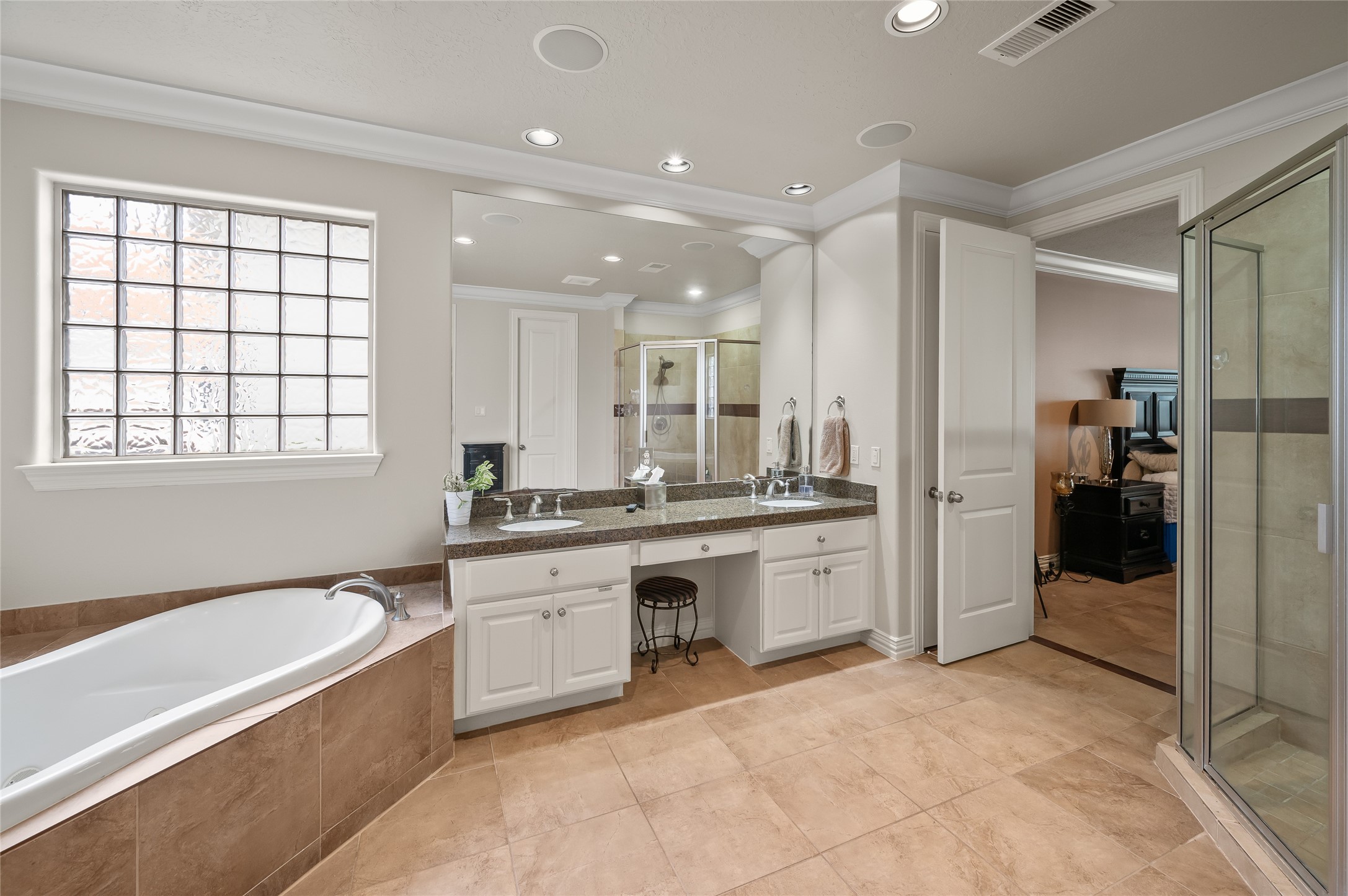 2127 Thicket Ridge Lane Houston, TX 77077 - Photo 21 of 48 The primary retreat is a sanctuary of sensory indulgence, featuring a spa-inspired bath with a deep soaking tub, a massive walk-in shower, and integrated in-ceiling speakers for an immersive escape. Thanks to the high-capacity tankless system, you can enjoy a limitless, therapeutic experience with an infinite supply of hot water—no timer, no limits, just pure relaxation.