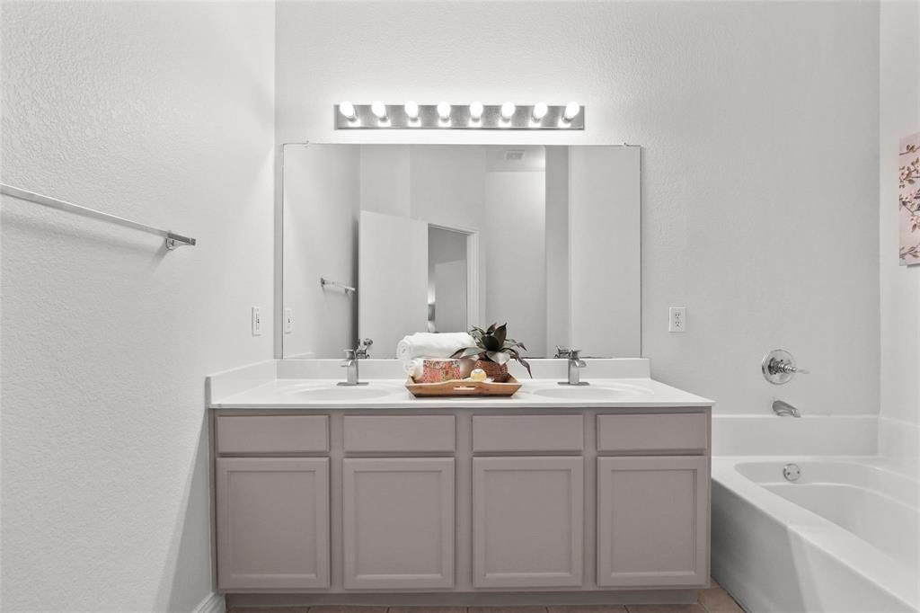 5961 Cheyenne Way Frisco, TX 75034 - Photo 22 of 33 Dual vanity featuring a light gray cabinet base, white countertop, and integrated sinks