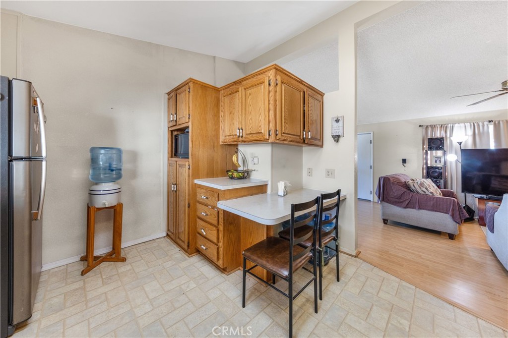 602 Roadrunner Way Perris, CA 92570 - Photo 18 of 27 a living room with furniture a flat screen tv and a refrigerator