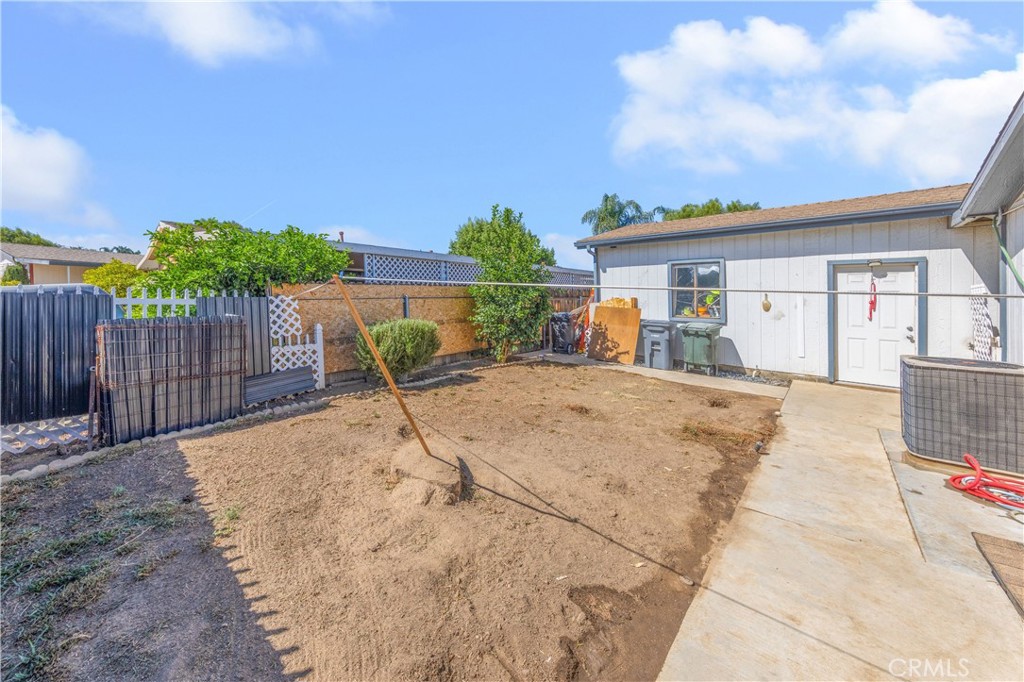 602 Roadrunner Way Perris, CA 92570 - Photo 20 of 27 a view of backyard with swimming pool and wooden fence