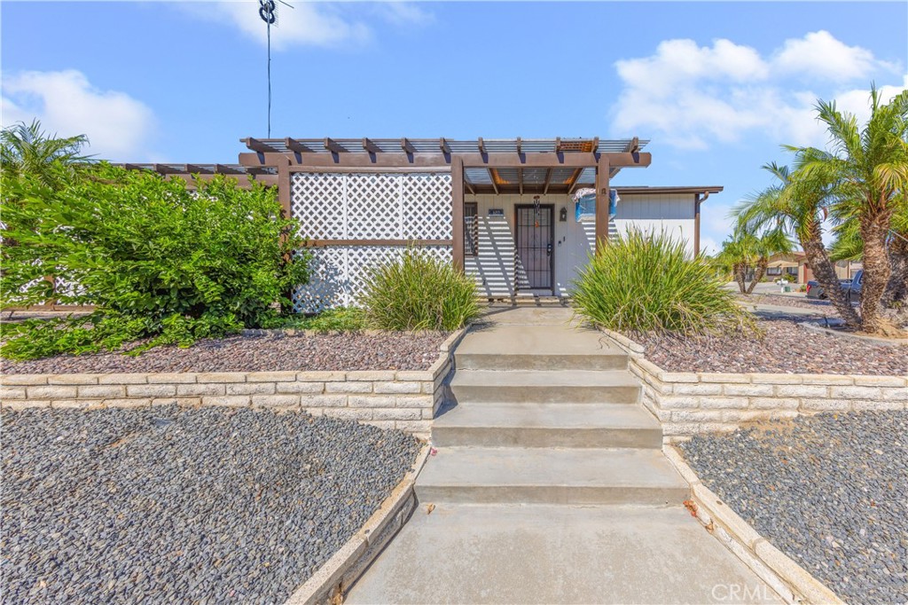 602 Roadrunner Way Perris, CA 92570 - Photo 5 of 27 a front view of a house with a garden and plants