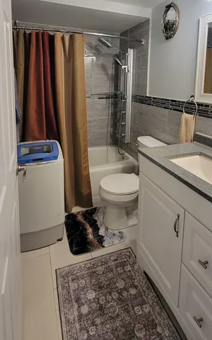 a bathroom with a toilet a sink and a shower