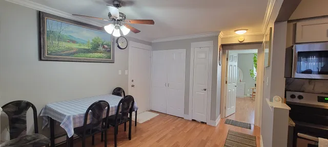 a view of a dining room with furniture and wooden floor