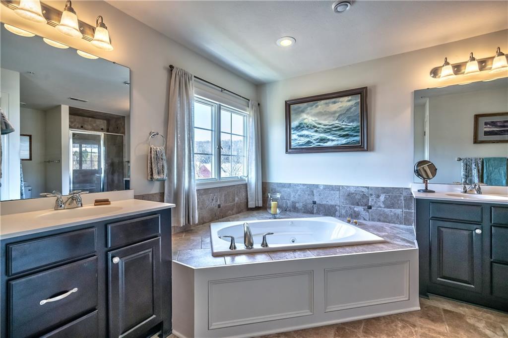 152 Harmony Road Wexford, PA 15090 - Photo 15 of 25 The bathroom is highlighted with dual separate vanities, a large jetted tub, ceramic floors & walk-in shower.