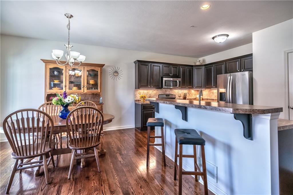 The dining room has an egress to the deck overlooking nature & trees