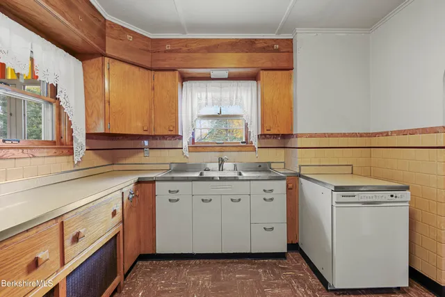 a kitchen with stainless steel appliances granite countertop a refrigerator and a stove