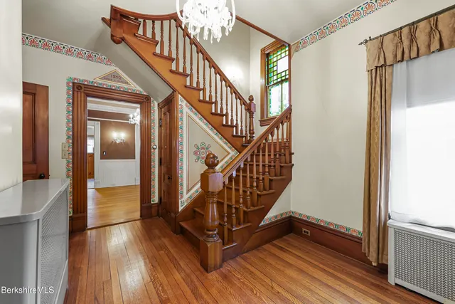 a view of an entryway wooden floor and stairs