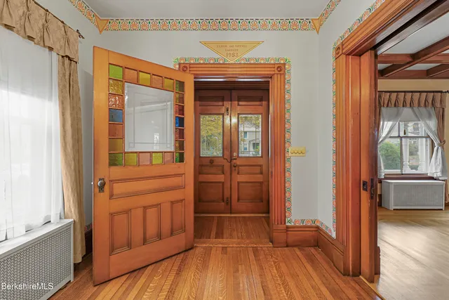 a view of front door with wooden floor