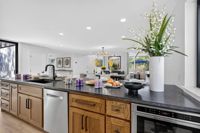 a kitchen with sink and white cabinets