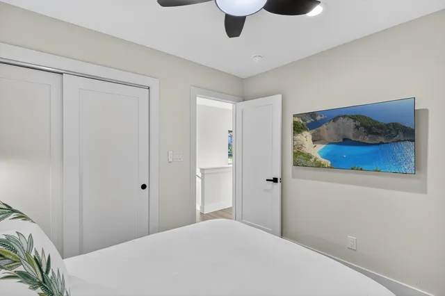 a bedroom with a bed and a painting on the wall