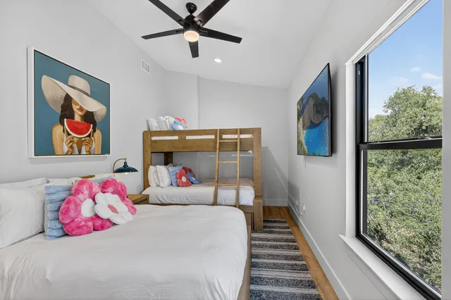 a bedroom with a bed and a painting on the wall