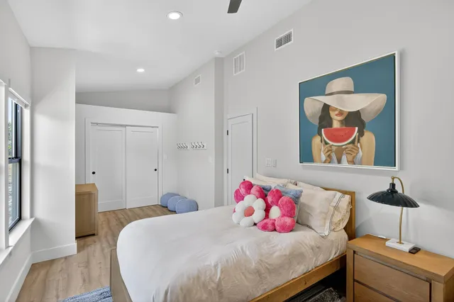 a bedroom with a bed and a dresser