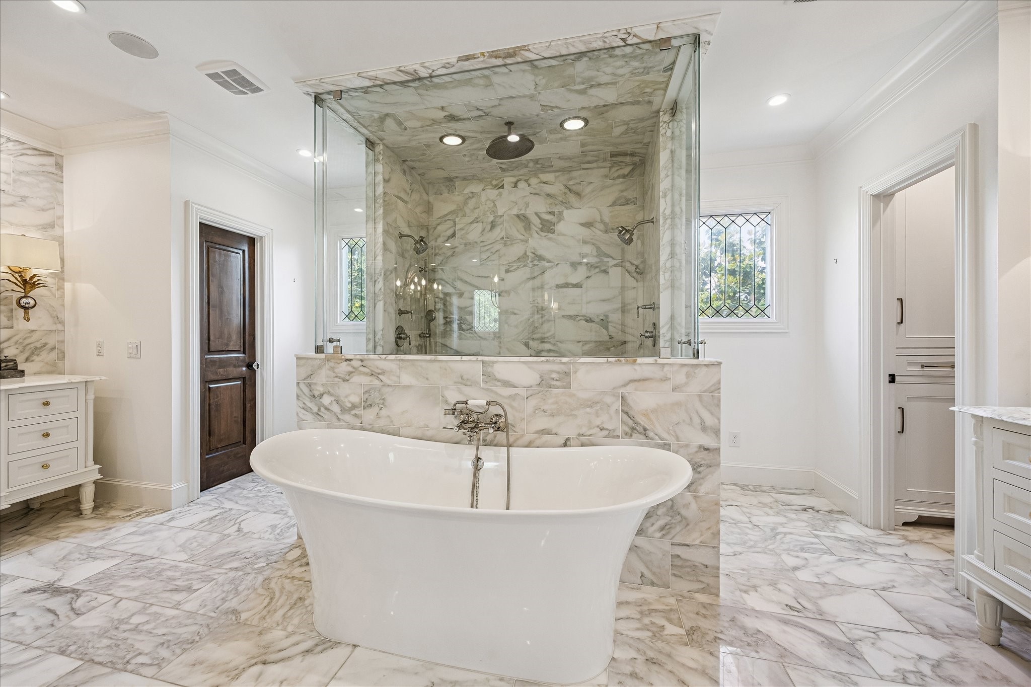 2368 Timber Lane Houston, TX 77027 - Photo 23 of 46 Designed with a spa-like atmosphere in mind, the primary bath offers multiple spaces to unwind and recharge. A freestanding Victoria + Albert soaking tub is paired with elegant Hansgrohe fixtures and a dedicated hand sprayer.