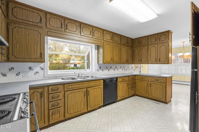 a kitchen with stainless steel appliances granite countertop a sink and cabinets