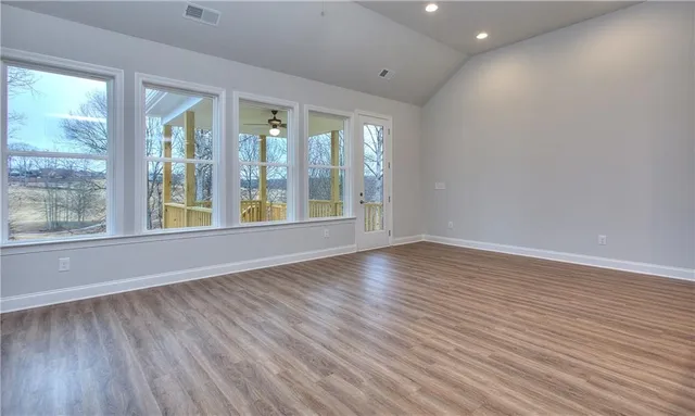 wooden floor in an empty room with a window