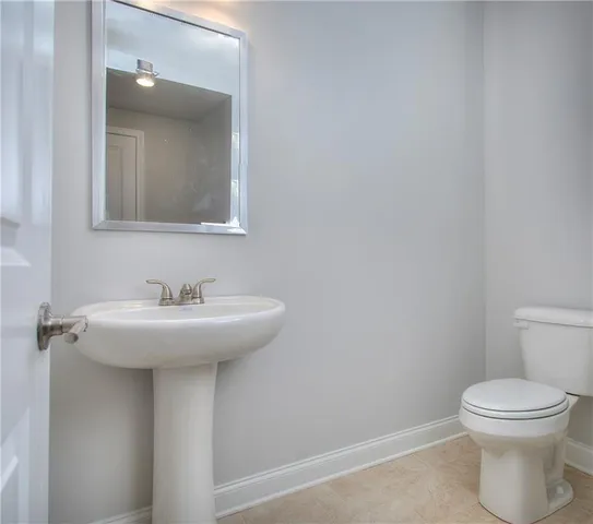 a bathroom with a sink a toilet and mirror