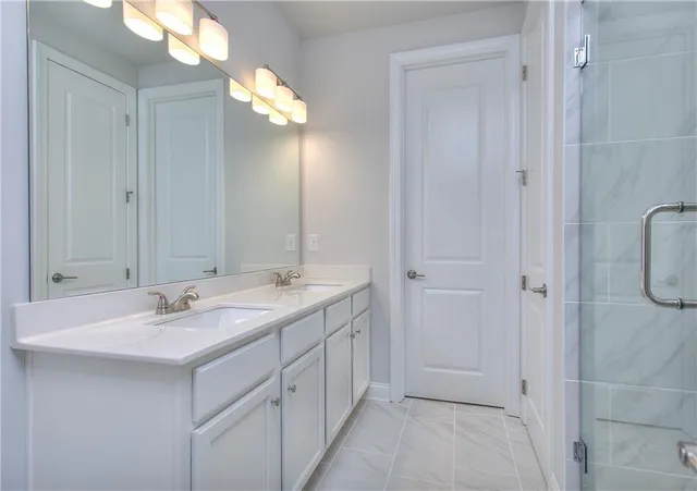 a bathroom with a double vanity sink and a mirror