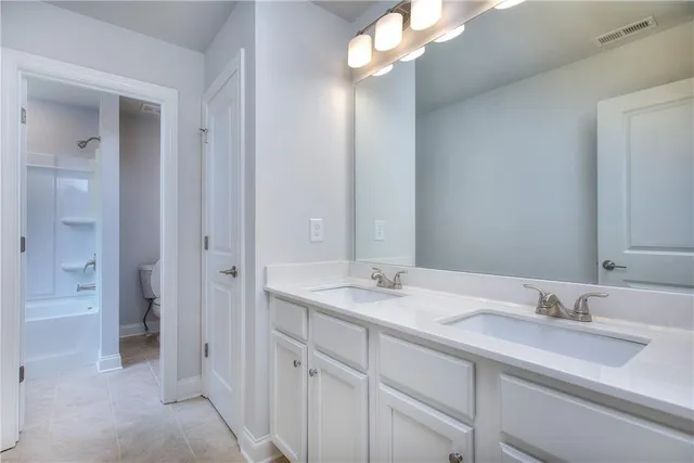a bathroom with a sink vanity granite and a mirror