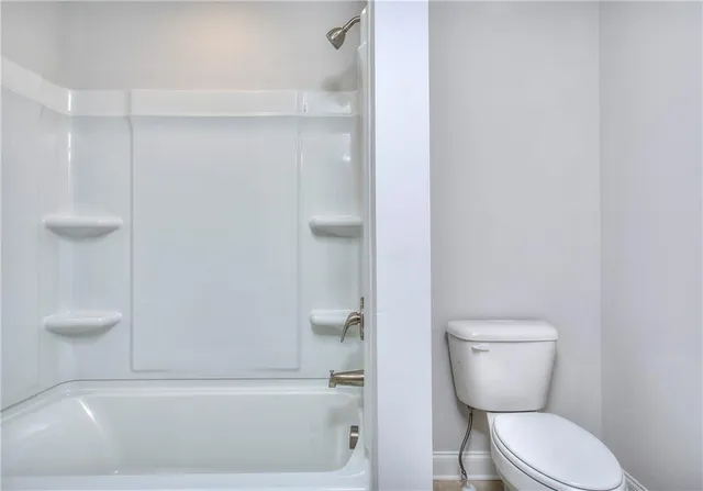 a bathroom with a toilet and a bathtub
